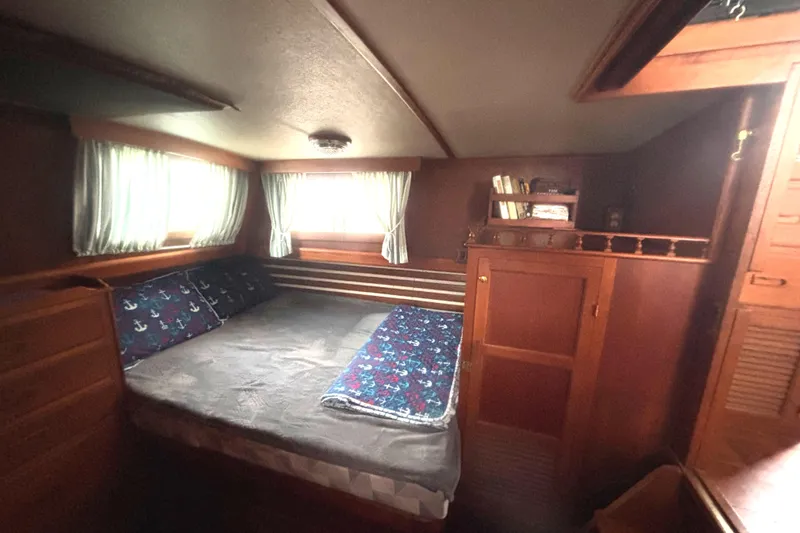 Slide: The Image of 1983 Albin Double Cabin interior with cozy bed and wooden furnishings. - 33