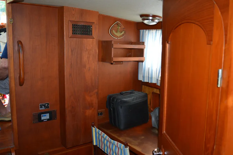 Slide: The Image of Interior of 1983 Albin Double Cabin with wooden furnishings and luggage. - 34