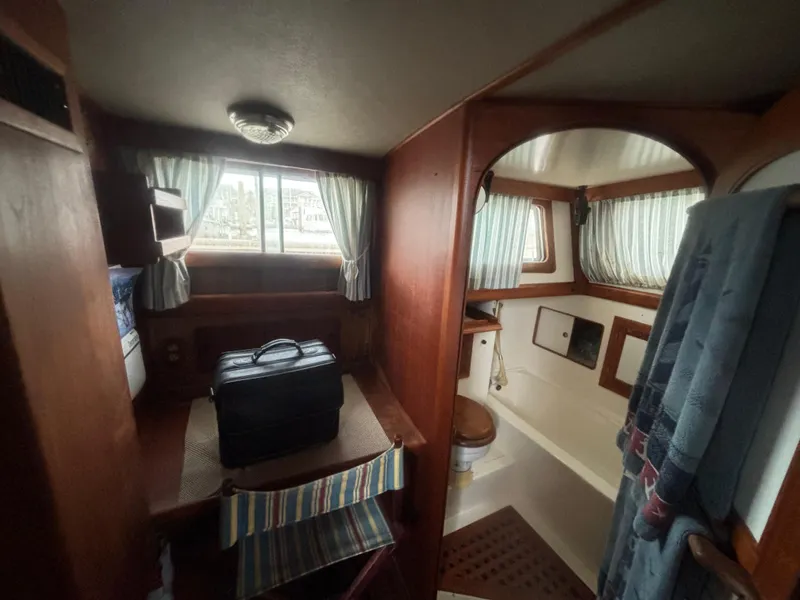 Slide: The Image of 1983 Albin Double Cabin interior with wood paneling and nautical decor. - 35