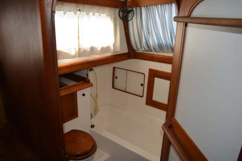Slide: The Image of 1983 Albin Double Cabin interior with wood accents and nautical decor. - 37