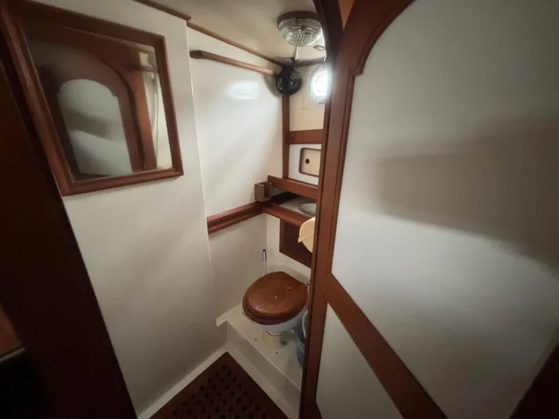 Slide: The Image of 1983 Albin Double Cabin boat bathroom with wooden accents and compact design. - 41