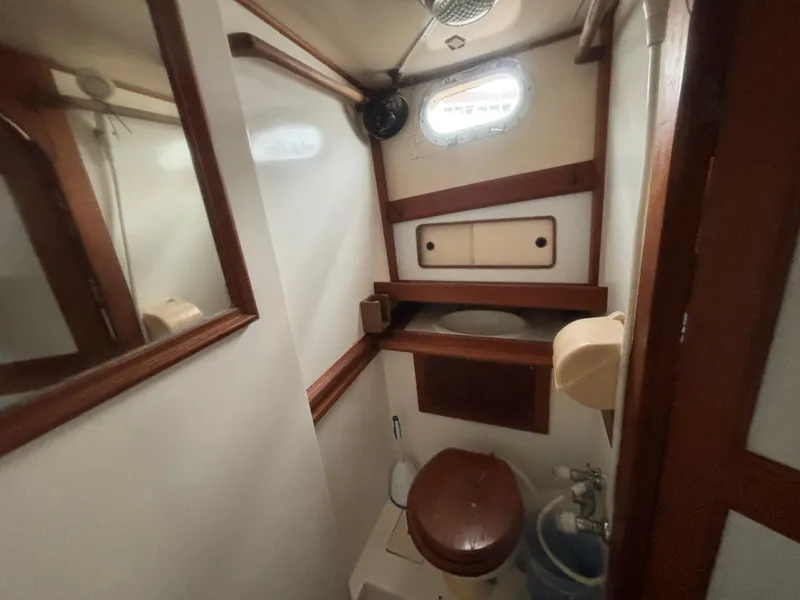 Slide: The Image of 1983 Albin Double Cabin boat bathroom with wooden accents and compact design. - 42