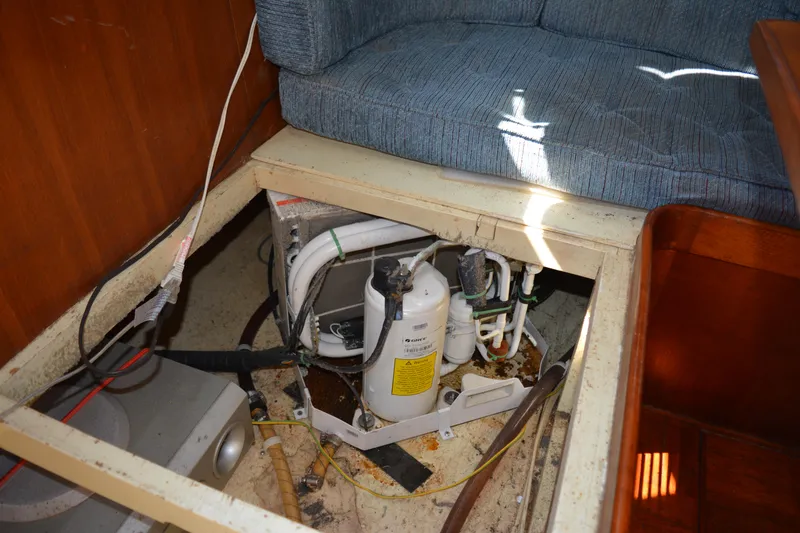 Slide: The Image of 1983 Albin Double Cabin interior showing exposed mechanical components under seating area. - 50
