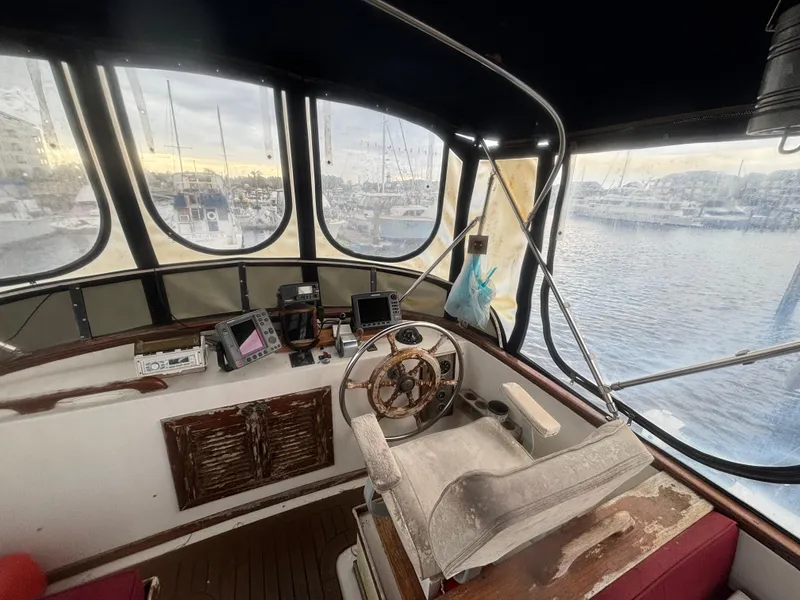 Slide: The Image of 1983 Albin Double Cabin boat interior with steering wheel and navigation equipment. - 9