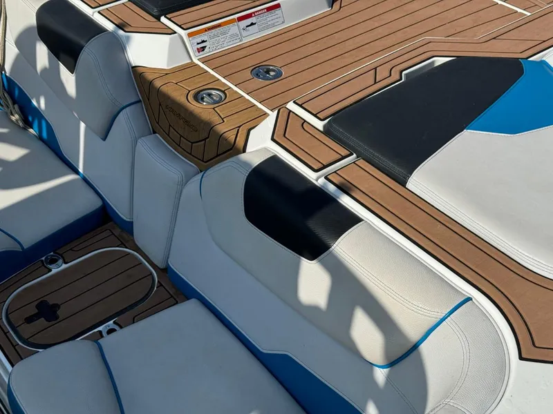 Slide: The Image of 2018 Nautique Super Air Nautique GS24 interior with teak flooring and cushioned seating. - 10