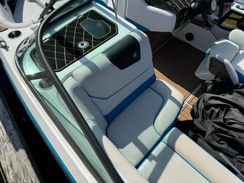 Slide: The Image of 2018 Nautique Super Air Nautique GS24 interior with cushioned seating and sleek design. - 11