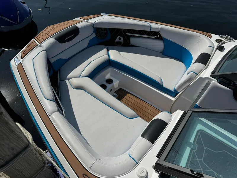 Slide: The Image of 2018 Nautique Super Air Nautique GS24 boat interior with white and blue seating. - 13