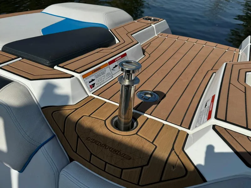 Slide: The Image of 2018 Nautique Super Air Nautique GS24 boat deck with teak finish and seating. - 19