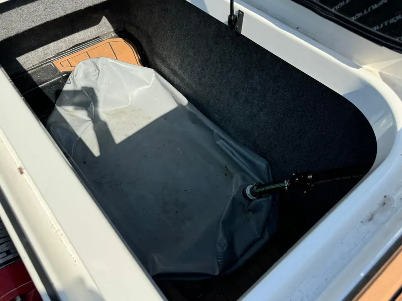 Slide: The Image of 2018 Nautique Super Air Nautique GS24 ballast compartment with gray ballast bag. - 21