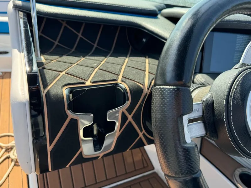 Slide: The Image of 2018 Nautique Super Air Nautique GS24 dashboard with steering wheel detail. - 24