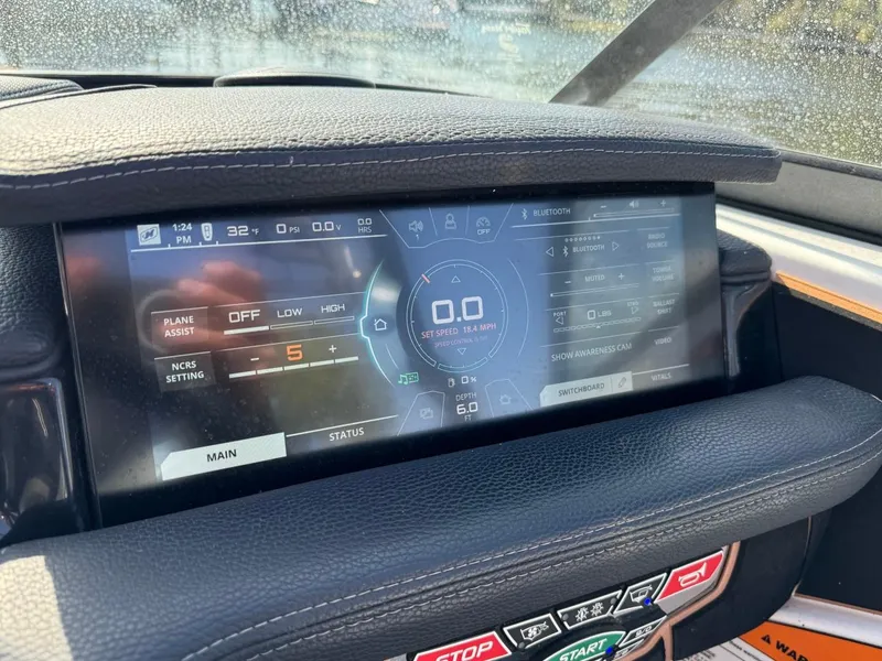 Slide: The Image of 2018 Nautique Super Air Nautique GS24 dashboard with digital display and controls. - 26