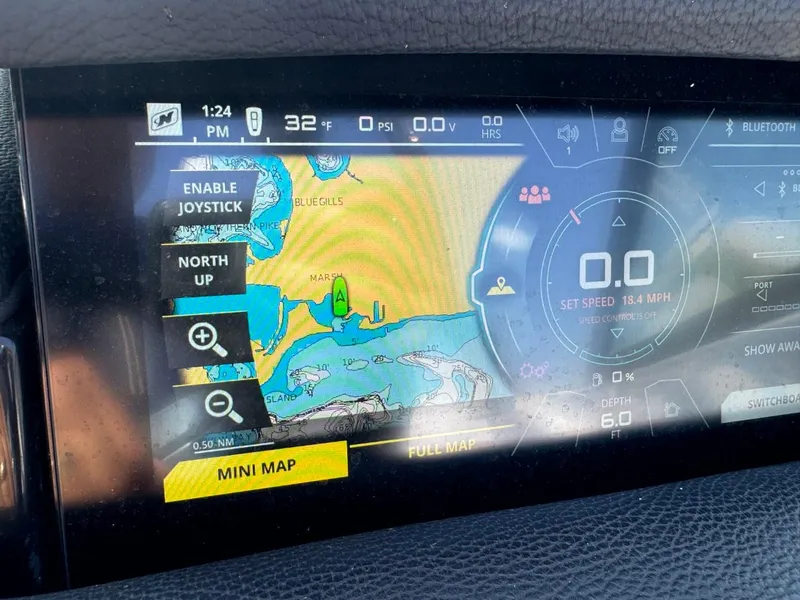 Slide: The Image of 2018 Nautique Super Air Nautique GS24 dashboard with navigation display and controls. - 31