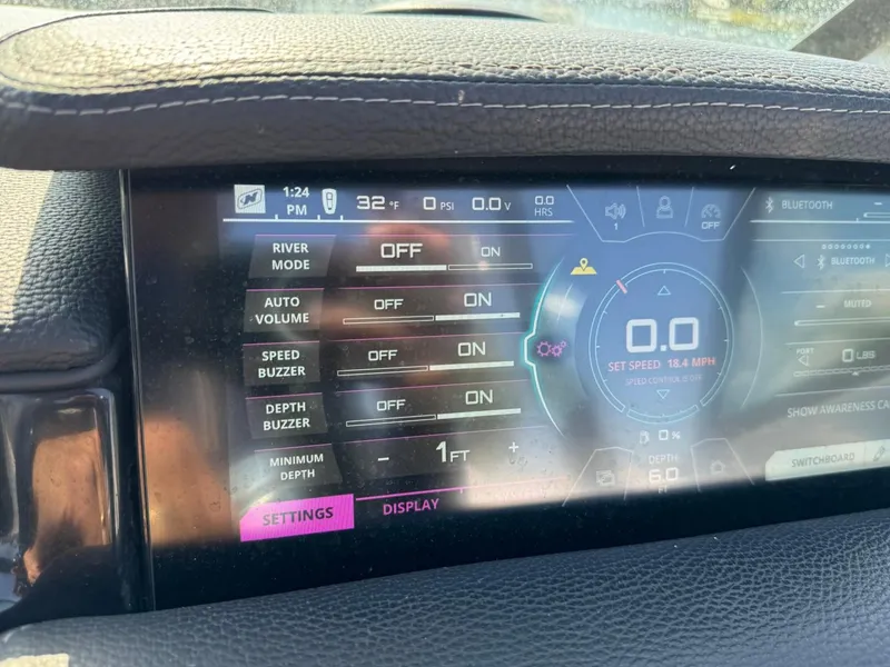 Slide: The Image of 2018 Nautique Super Air Nautique GS24 dashboard display with various settings and controls. - 32