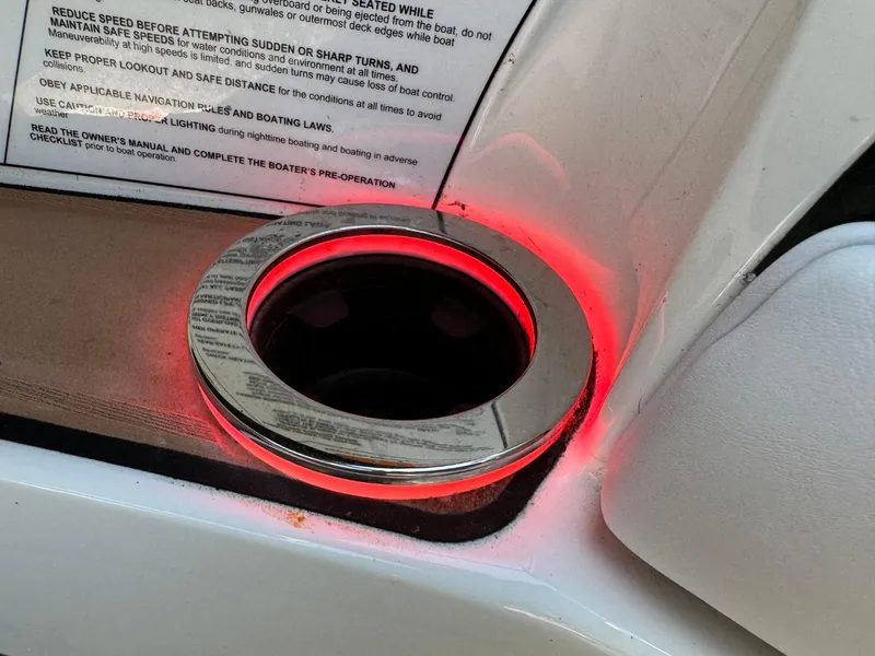 Slide: The Image of Illuminated cup holder in 2018 Nautique Super Air Nautique GS24 boat interior. - 39