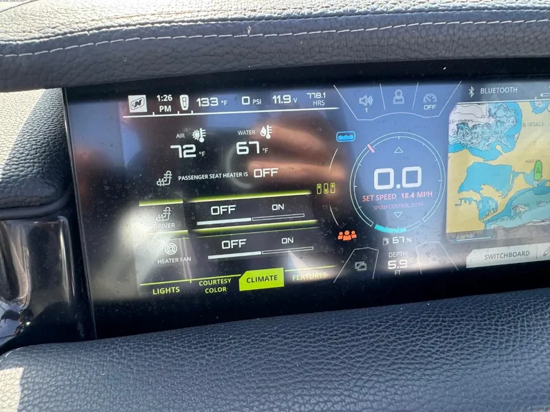 Slide: The Image of Dashboard of a 2018 Nautique Super Air Nautique GS24 boat showing climate controls and navigation. - 40