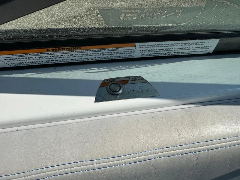 Slide: The Image of 2018 Nautique Super Air Nautique GS24 interior detail with warning label and button. - 41