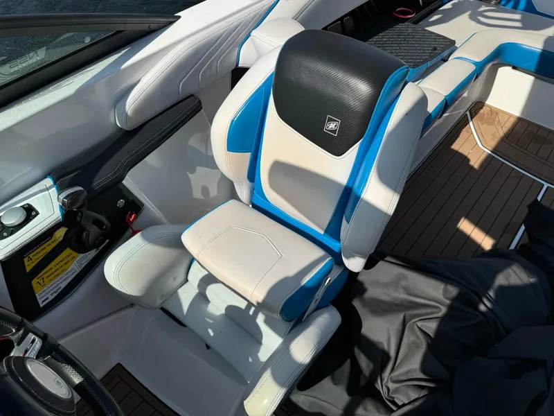 Slide: The Image of 2018 Nautique Super Air Nautique GS24 interior with blue and white seating. - 42