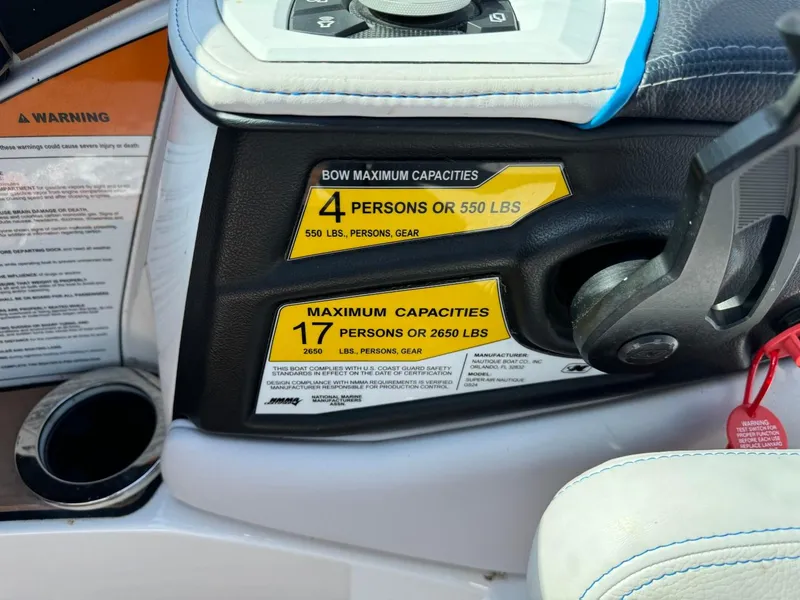 Slide: The Image of 2018 Nautique Super Air Nautique GS24 capacity labels, showing limits for passengers and weight. - 43