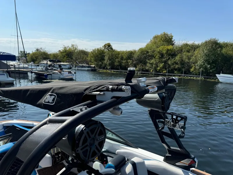Slide: The Image of 2018 Nautique Super Air Nautique GS24 docked in a scenic marina. - 48