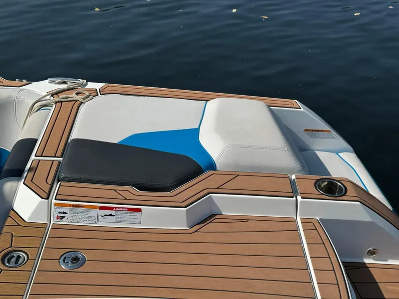 Slide: The Image of 2018 Nautique Super Air Nautique GS24 boat deck with wood finish and seating. - 8
