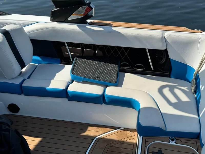 Slide: The Image of 2018 Nautique Super Air Nautique GS24 interior with blue and white seating. - 9