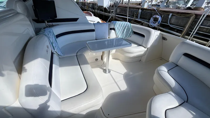 Slide: The Image of Luxurious seating area on 2008 Sea Ray 380 Sundancer yacht with table and cushions. - 11