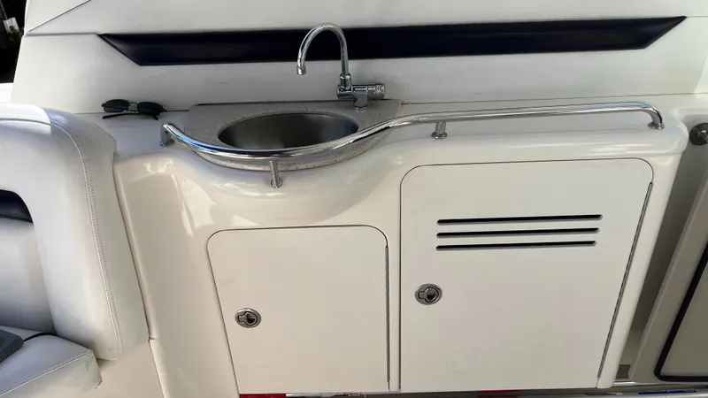 Slide: The Image of 2008 Sea Ray 380 Sundancer boat kitchenette with sink and storage cabinets. - 14