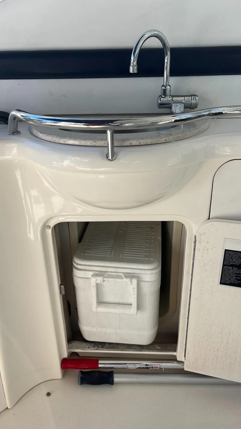 Slide: The Image of 2008 Sea Ray 380 Sundancer boat sink with storage compartment and cooler. - 16