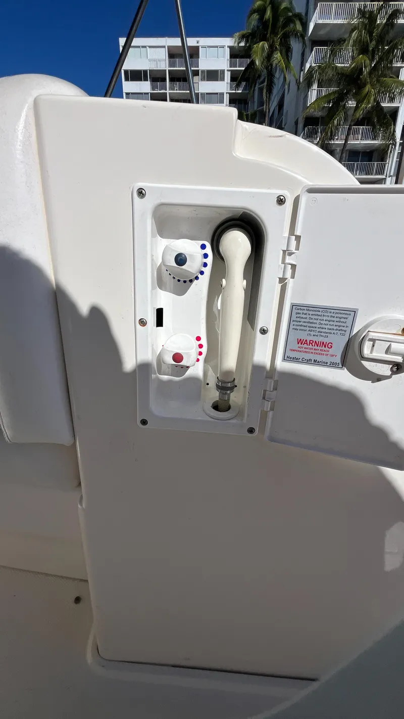 Slide: The Image of 2008 Sea Ray 380 Sundancer boat control panel with knobs and warning label. - 21