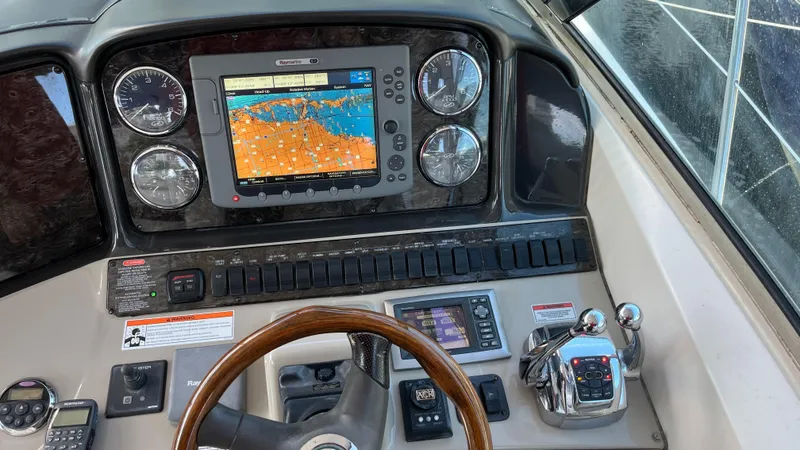 Slide: The Image of Cockpit of 2008 Sea Ray 380 Sundancer with navigation system and controls. - 24