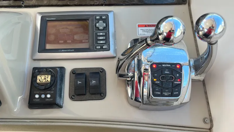 Slide: The Image of Control panel of a 2008 Sea Ray 380 Sundancer boat with navigation and throttle controls. - 26