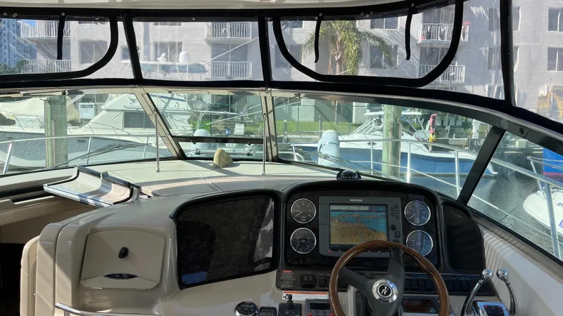 Slide: The Image of Cockpit view of 2008 Sea Ray 380 Sundancer with navigation system and marina backdrop. - 31