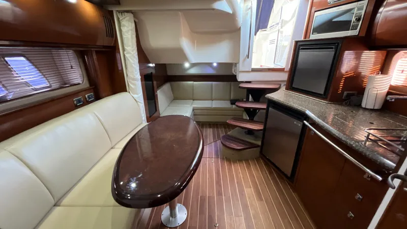 Slide: The Image of Luxurious interior of 2008 Sea Ray 380 Sundancer yacht with modern kitchen and seating area. - 36
