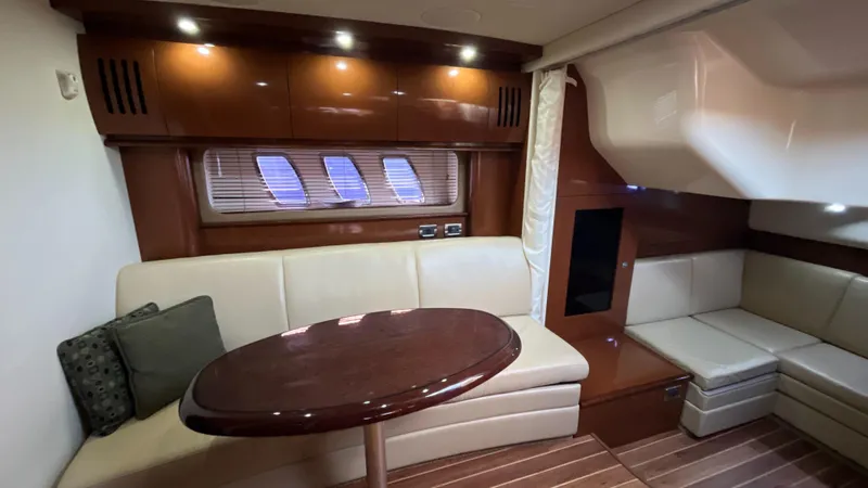 Slide: The Image of Luxurious interior of 2008 Sea Ray 380 Sundancer yacht with elegant seating and wooden table. - 37