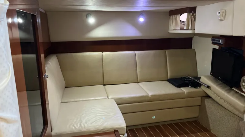Slide: The Image of Luxurious interior of 2008 Sea Ray 380 Sundancer with beige leather seating and wood accents. - 39