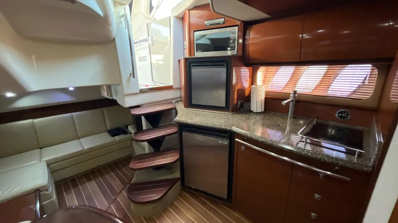 Slide: The Image of Interior of 2008 Sea Ray 380 Sundancer yacht with kitchen and seating area. - 42