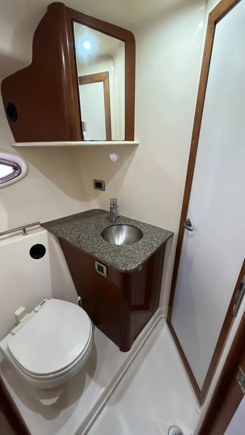 Slide: The Image of 2008 Sea Ray 380 Sundancer bathroom with sink, toilet, and mirror. - 47