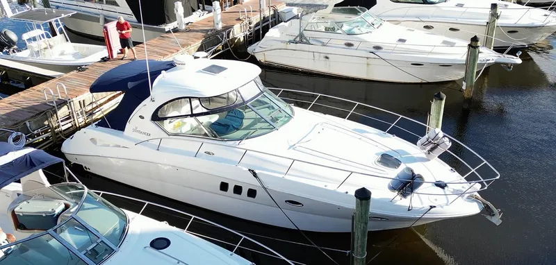 Slide: The Image of 2008 Sea Ray 380 Sundancer yacht docked at marina, surrounded by other boats. - 5
