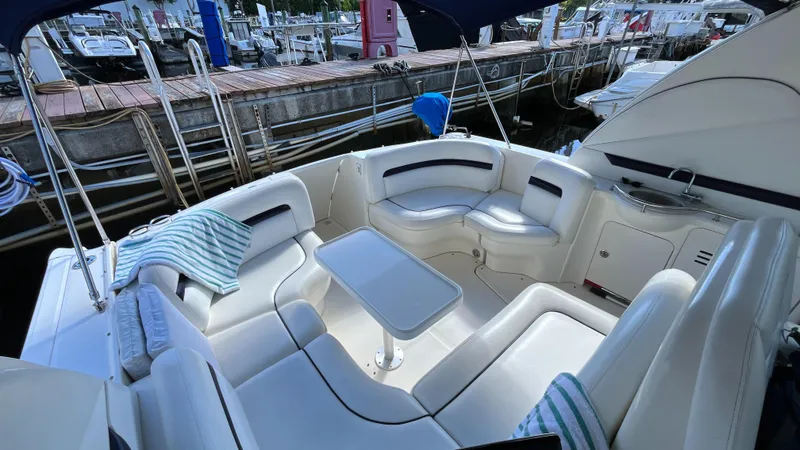 Slide: The Image of 2008 Sea Ray 380 Sundancer yacht with spacious seating and table at marina. - 9
