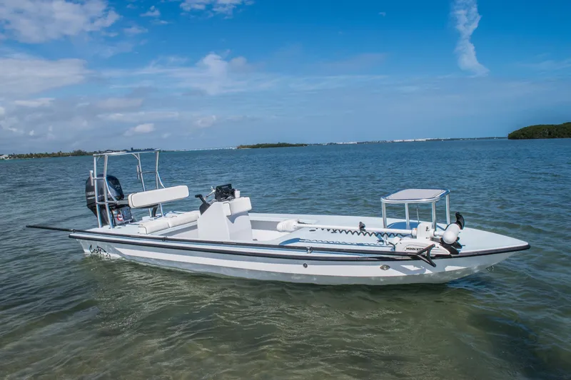 Slide: The Image of 2025 Cayo Boatworks 180 MV skiff on calm water under blue sky. - 10