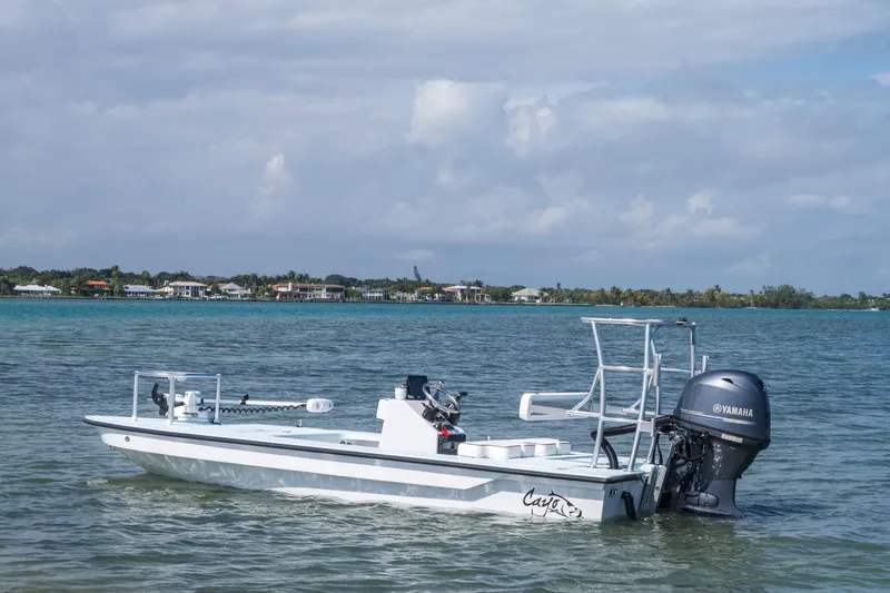 Slide: The Image of 2025 Cayo Boatworks 180 MV on calm water with Yamaha outboard motor. - 9