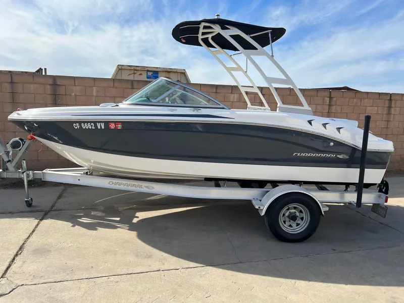 The Image of 2017 Chaparral 19 H2O Sport boat on trailer, parked outdoors. - 0