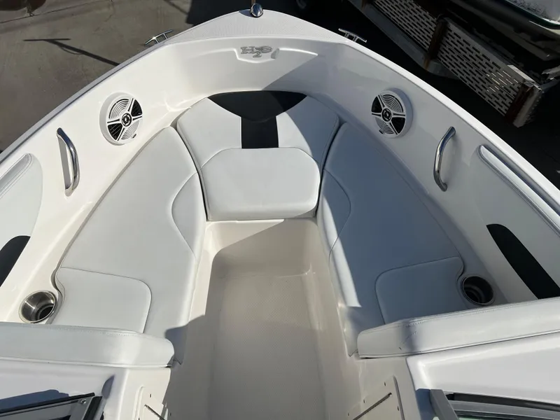 Slide: The Image of 2017 Chaparral 19 H2O Sport boat interior with white seating and speakers. - 11