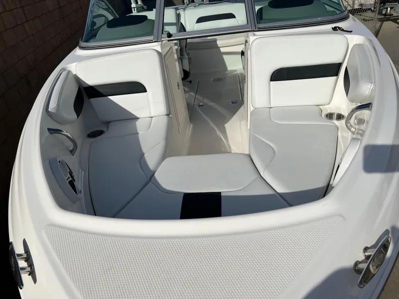 Slide: The Image of 2017 Chaparral 19 H2O Sport boat interior with white seating and cup holders. - 12