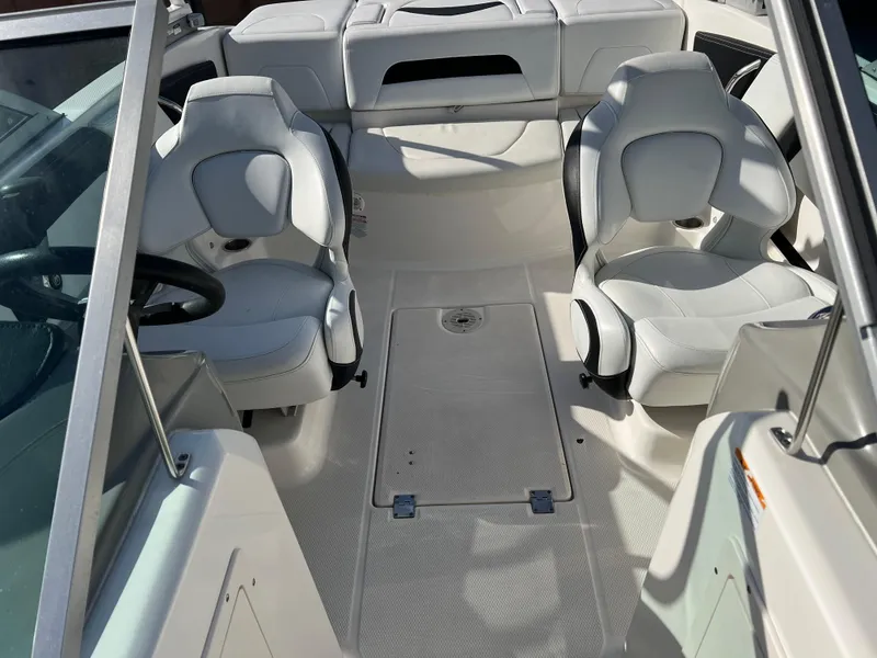 Slide: The Image of 2017 Chaparral 19 H2O Sport boat interior with white seating and spacious layout. - 16