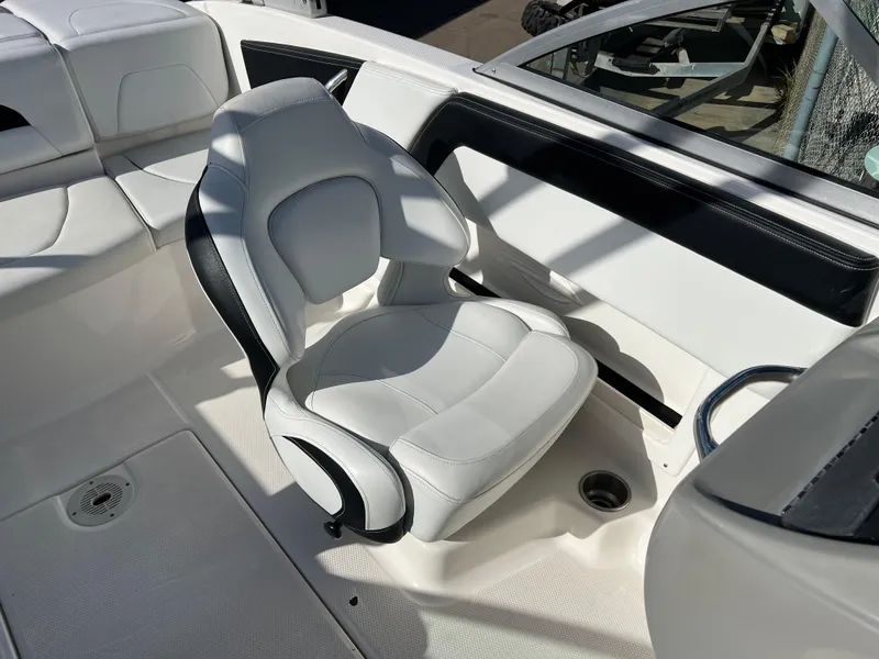 Slide: The Image of 2017 Chaparral 19 H2O Sport boat interior with white seating and sleek design. - 17