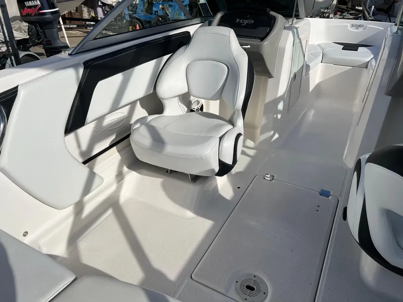 Slide: The Image of 2017 Chaparral 19 H2O Sport boat interior with white seating and sleek design. - 19
