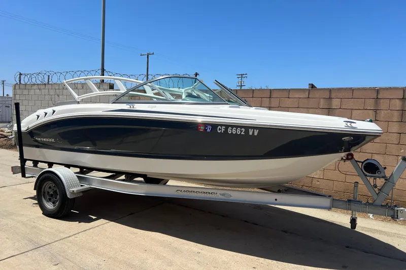 Slide: The Image of 2017 Chaparral 19 H2O Sport boat on trailer, parked outdoors. - 2