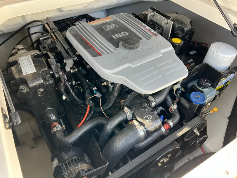 Slide: The Image of 2017 Chaparral 19 H2O Sport engine compartment with MerCruiser 180 engine. - 23