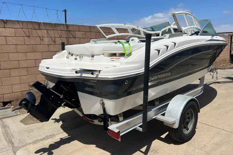 Slide: The Image of 2017 Chaparral 19 H2O Sport boat on trailer, parked outdoors. - 28